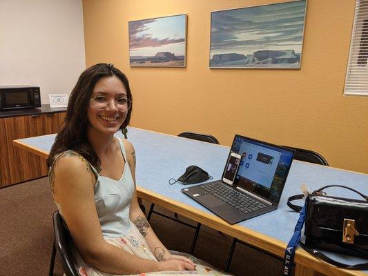 language exchange participant smiling in front of computer