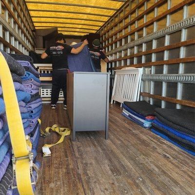 Wrapping each piece of furniture with professional moving blankets.