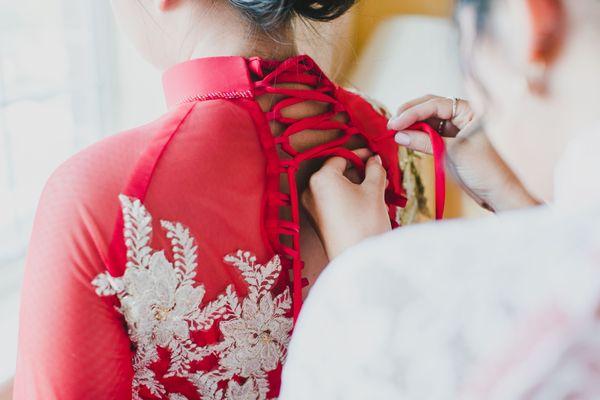 My traditional dress was too small and couldn't zip up in the back so she used string and a shoelace concept to lace it up in the back!