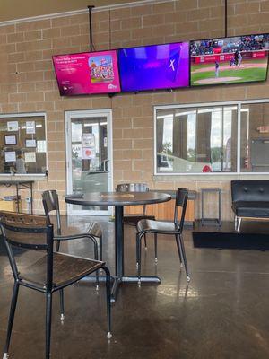 Watching your car being washed on a 90 degree day while in the cool ac relaxing clean chill area with tvs