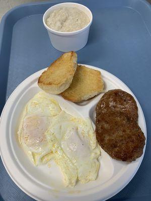 Eggs sausage patties grits and a toasted bun to go with it yum