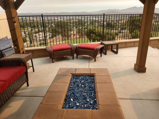 fire pit with glass, patio, wall, wrought iron,