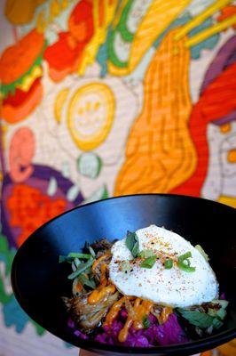 Hawaiian Bibimbap: Hawaiian pulled pork, fried egg, pickled vegetables, cucumber, pineapple, onion, gochujang mayo, toasted sesame ($15).