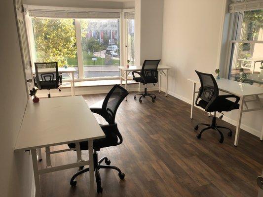 Well-lit reserved desk space with gorgeous views