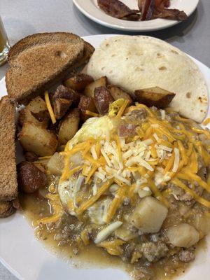 huevos rancheros with tortillas, side of toast and bacon