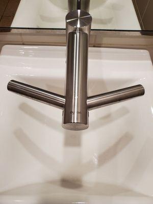 A faucet in the middle and dryers on the sides... very interesting LOL