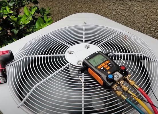 Service tech from AC Repair in Danville, CA, performing a maintenance check on our air conditioning.