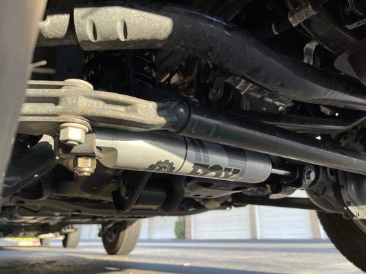 Mopar/Fox steering stabilizer added with suspension and lift installation.
