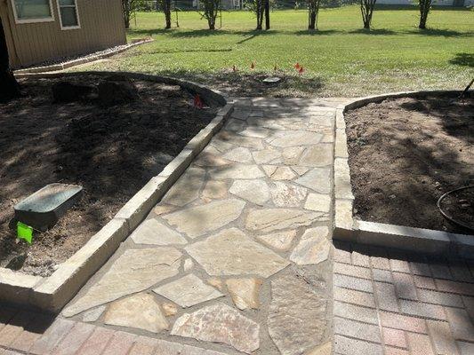 Flagstone walkway and stone flowerbed