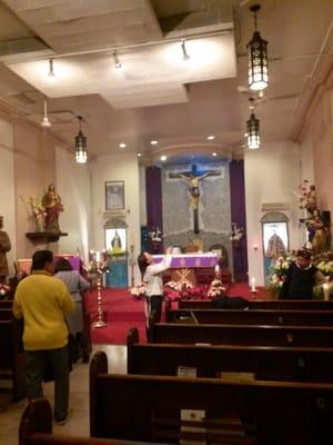 Inside d church, during d evening mass for d feast of the immaculate conception