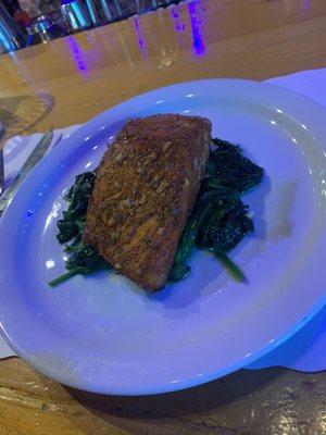 Blackened salmon over a bed of spinach