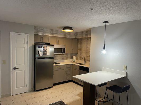 Kitchenette with dishwasher and well sized refrigerator.