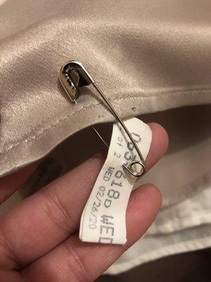 Every shirt has a hole after I asked them to put the safety pin through the hole for the button.