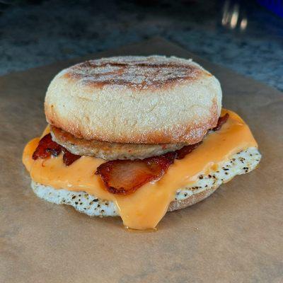 Bacon, sausage, egg, and cheese on an English muffin.