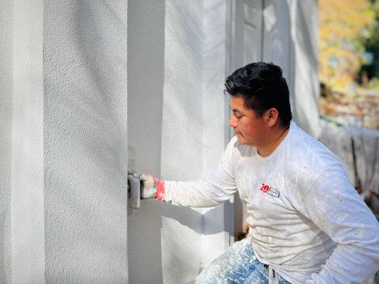 Application of the final coat of stucco.