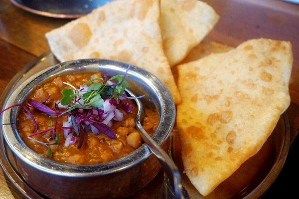 Channa Bhatura: garbanzo beans, garlic oil, roasted garam spices, puff wok fried bread ($17).