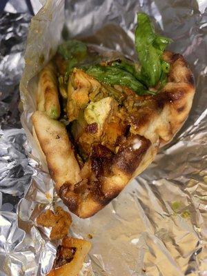Chicken gyro with green sauce and hot sauce.