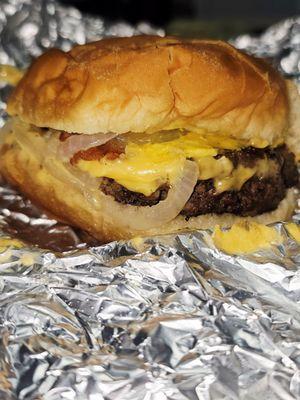 Cheeseburger with bacon, grilled onions, and mustard.