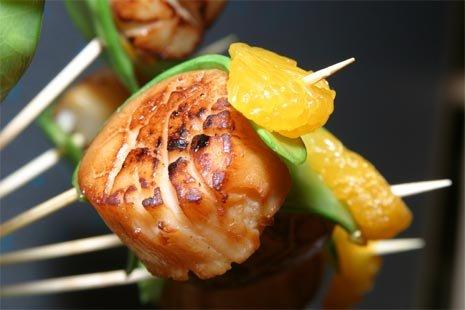 Specialty appetizer of seared scallop with snow pea and mandarin orange