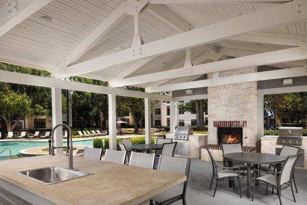 Outdoor lounge with BBQ grills, fireplace and seating