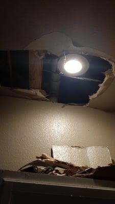 Hole that was cut to find source of water leak. They refused to cover it with wood as i requested and stated they didnt have any.