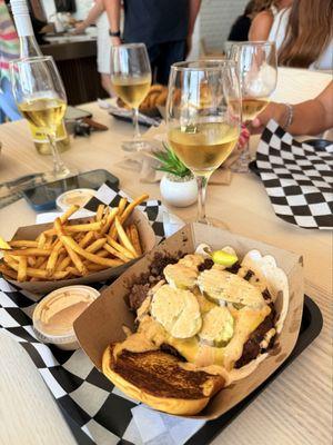 Double smash burger and fries with white wine