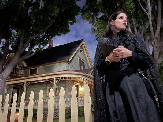 Valerie striking a haunting pose in front of one of the haunted houses in Old town Orange.