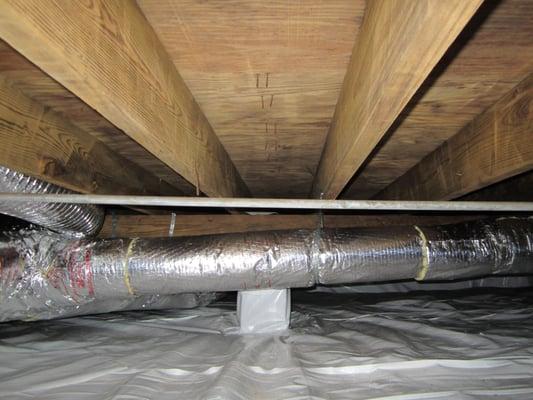 This is the same crawlspace in the previous picture, after we soda blasted the mold off the floor joists and subfloor and ins...