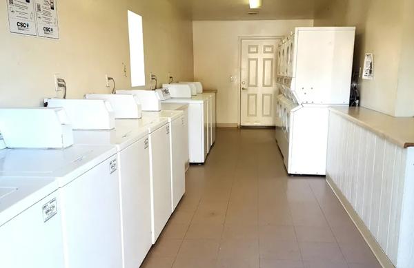 A laundry room with washers and dryers.