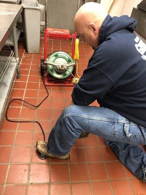 Cleaning a floor drain for a local business