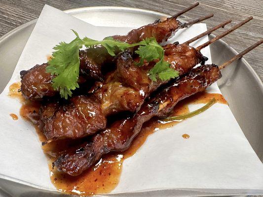 Moo-Ping, traditional Thai street food. Grilled pork skewers. Super yummy with sticky rice.