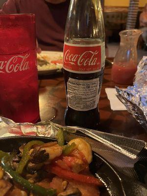Mexican coke and shrimp fajitas with corn tortillas.