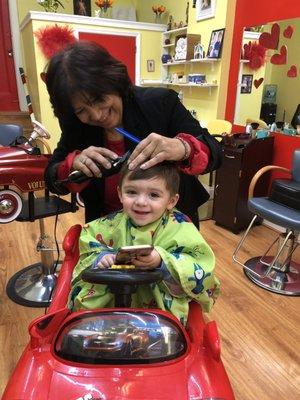 Happy boy while cutting his hair.