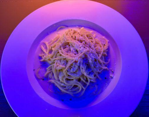 Cacio e Pepe (light on the pepper by request) with some interesting bar lighting, March 2025.
