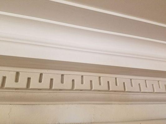This is a photo of a crown moulding with a Greek Key detail that we totally restored and made 80 feet more for an adjacent space.