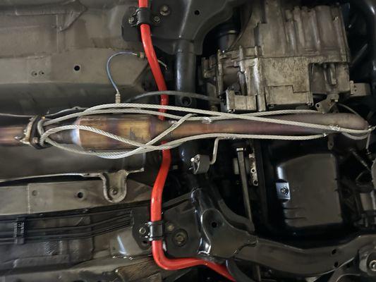 Steel wire rope around catalytic converter