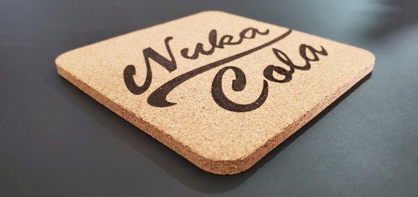 We laser engrave cork, these are coasters we made for me.
