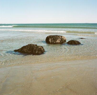 Sandy Point State Beach in Ipswich MA. Tip of Plum Island. Outgoing tide leaves many rocks exposed. Turning tides impressive High to Low.