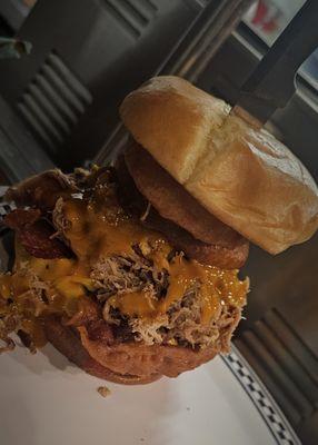 The "TinCan" Burger
(Bacon CheeseBurger Topped w/ Smoked Pork Fried Onion Rings & Your Choice of BBQ Sauce)