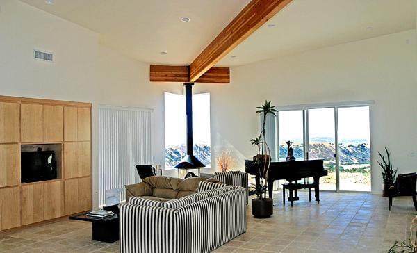 Unique design allowed the main roof beam to terminate before the fireplace chimney to allow a full height wood burning Stove.