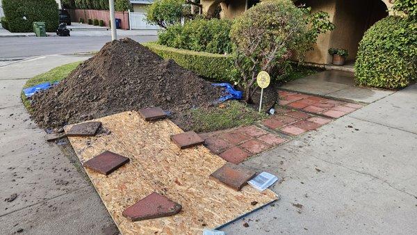 Digging hole to expose pipe