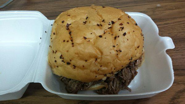 Beef au jus sandwich on an onion bun.