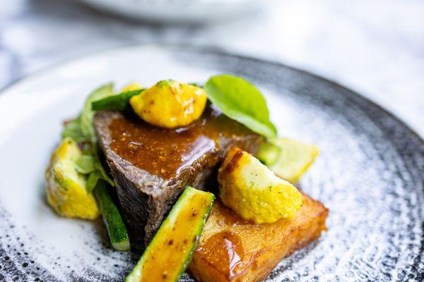 Braised Boneless Short Rib ($44) potato pavé, baby sunburst squash, mustard demi-glace