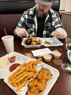 Fried shrimp platter with coleslaw and fries.