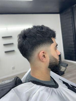Low skin fade with faded beard