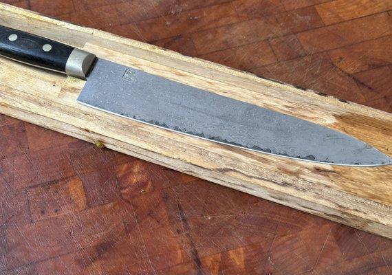 Hattori KD30 COWRY-X 121 (layered Damascus steel Gyuto) and ordered a titanium cutting board and now the old butcher block's obsolete