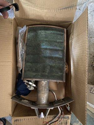 Worn-out manifold component block with visible hole in screen.