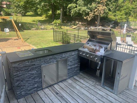 Outdoor kitchen area with leather finish granite by GLC