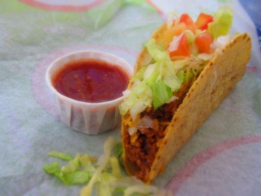 Crunchy ground beef taco and original hot sauce