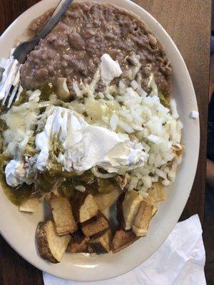 Yummy - shredded chicken on tortilla chips...topped with verde and sour cream